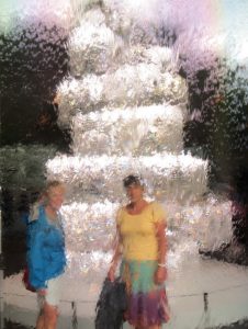 Impressionist photo of Pam & Julie behind a waterfall pane